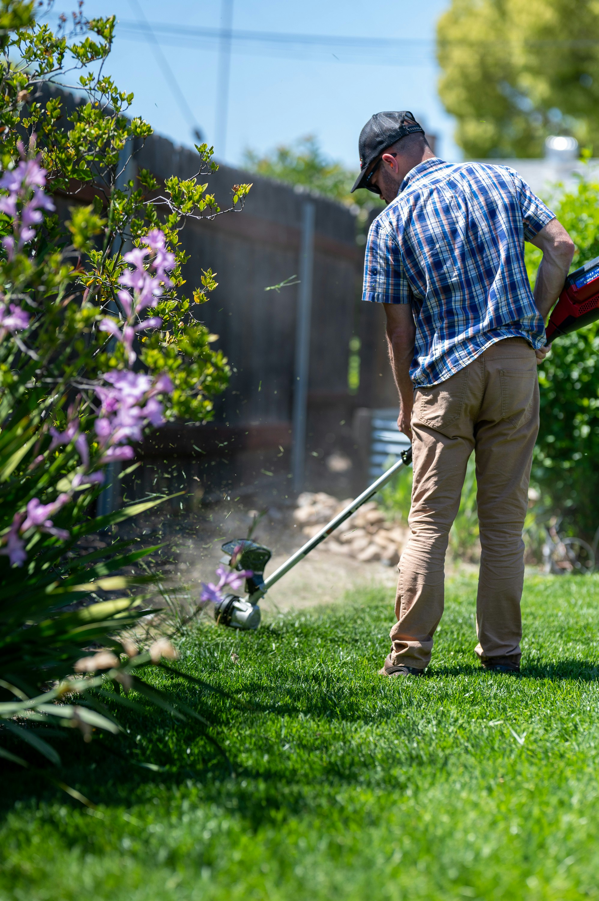 Professional lawn care technician mowing and maintaining a residential lawn in Loudoun County, Virginia.